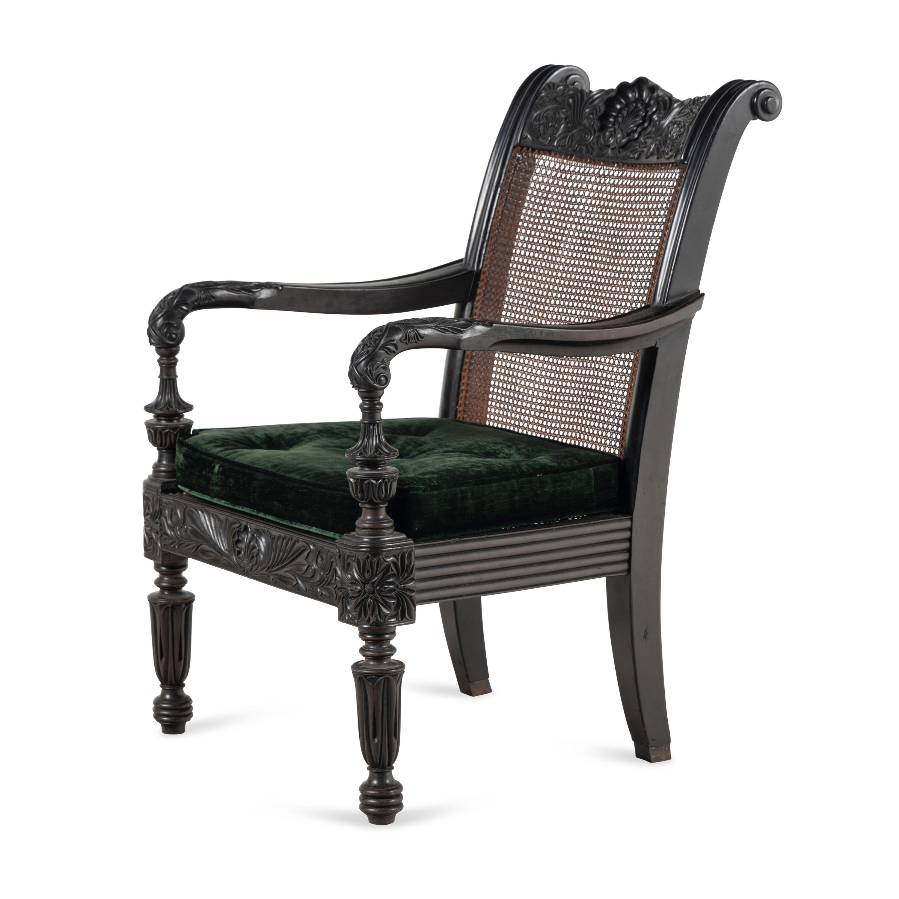 An Anglo-Colonial Carved Ebony and Caned Armchair