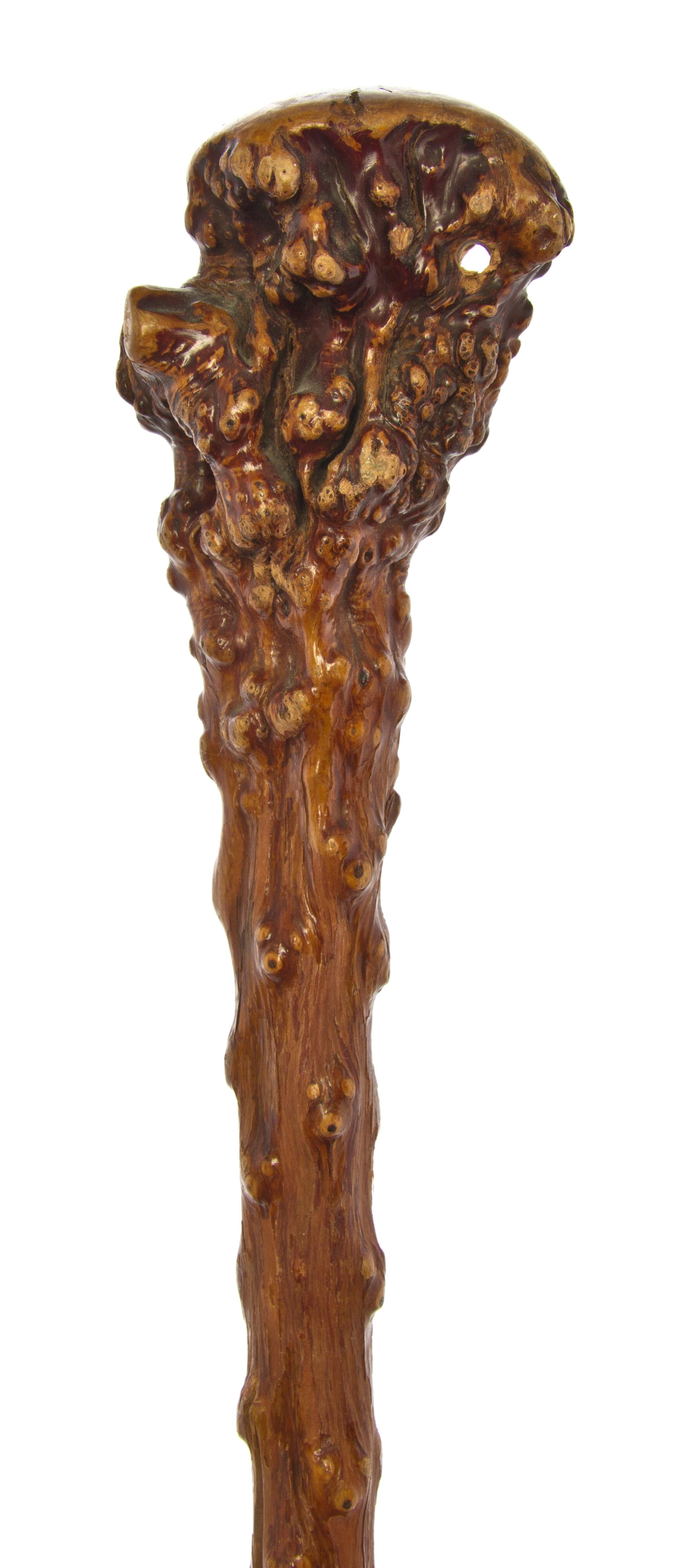 A Carved Wood Walking Stick, Length of handle 3 x length overall 35 inches.