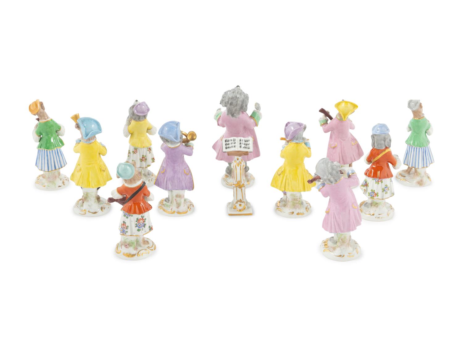 An Assembled Group of Twelve Continental Porcelain Dog Band Figures