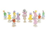 An Assembled Group of Twelve Continental Porcelain Dog Band Figures