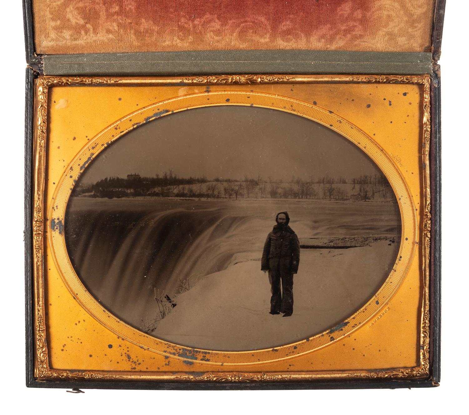 [EARLY PHOTOGRAPHY]. LAWRENCE, Martin M., photographer. Whole plate ambrotype of a man posed in front of Niagara Falls. New York, NY: ca 1853-1860.