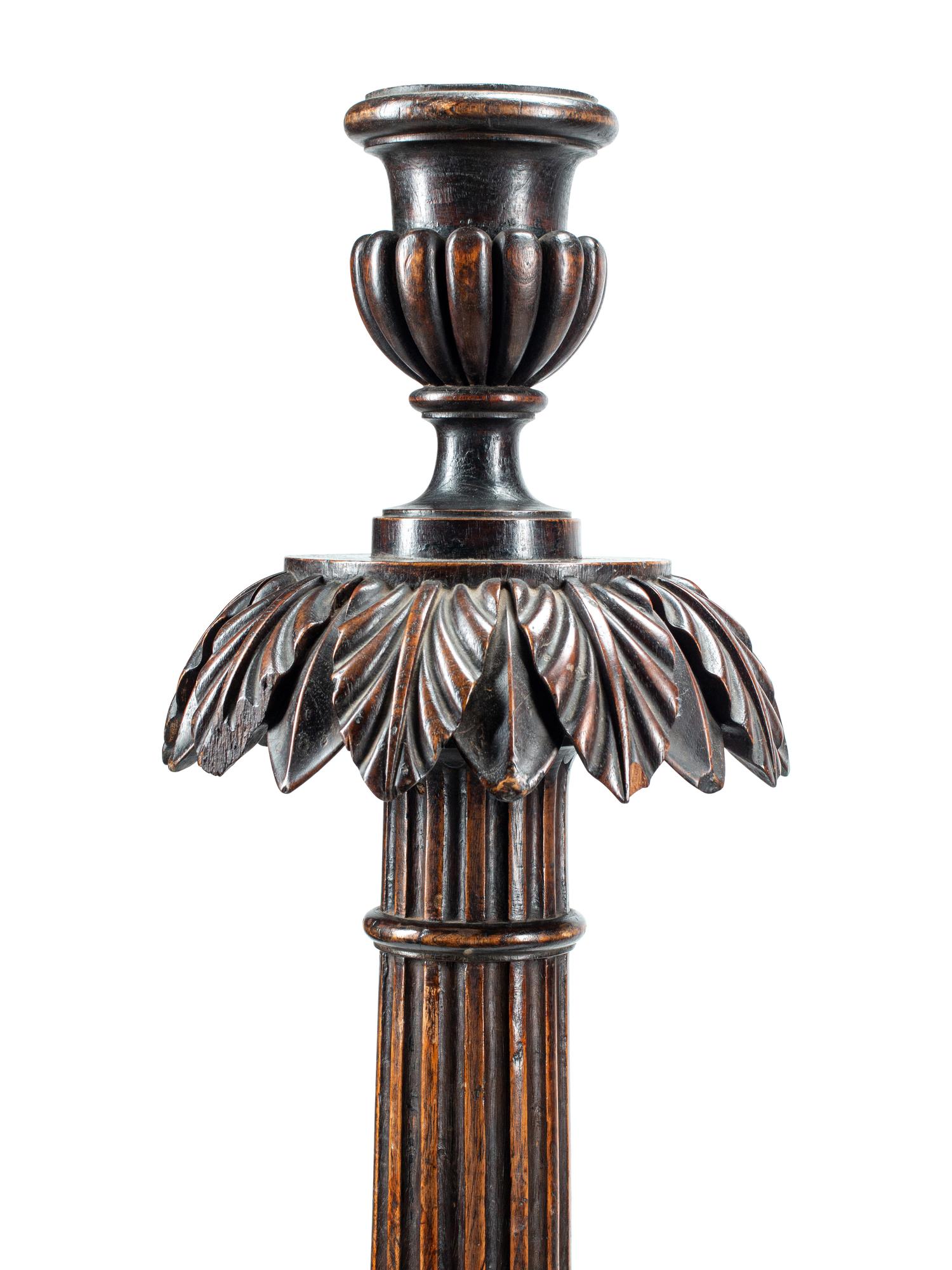 A Pair of Italian Carved Walnut Torchères