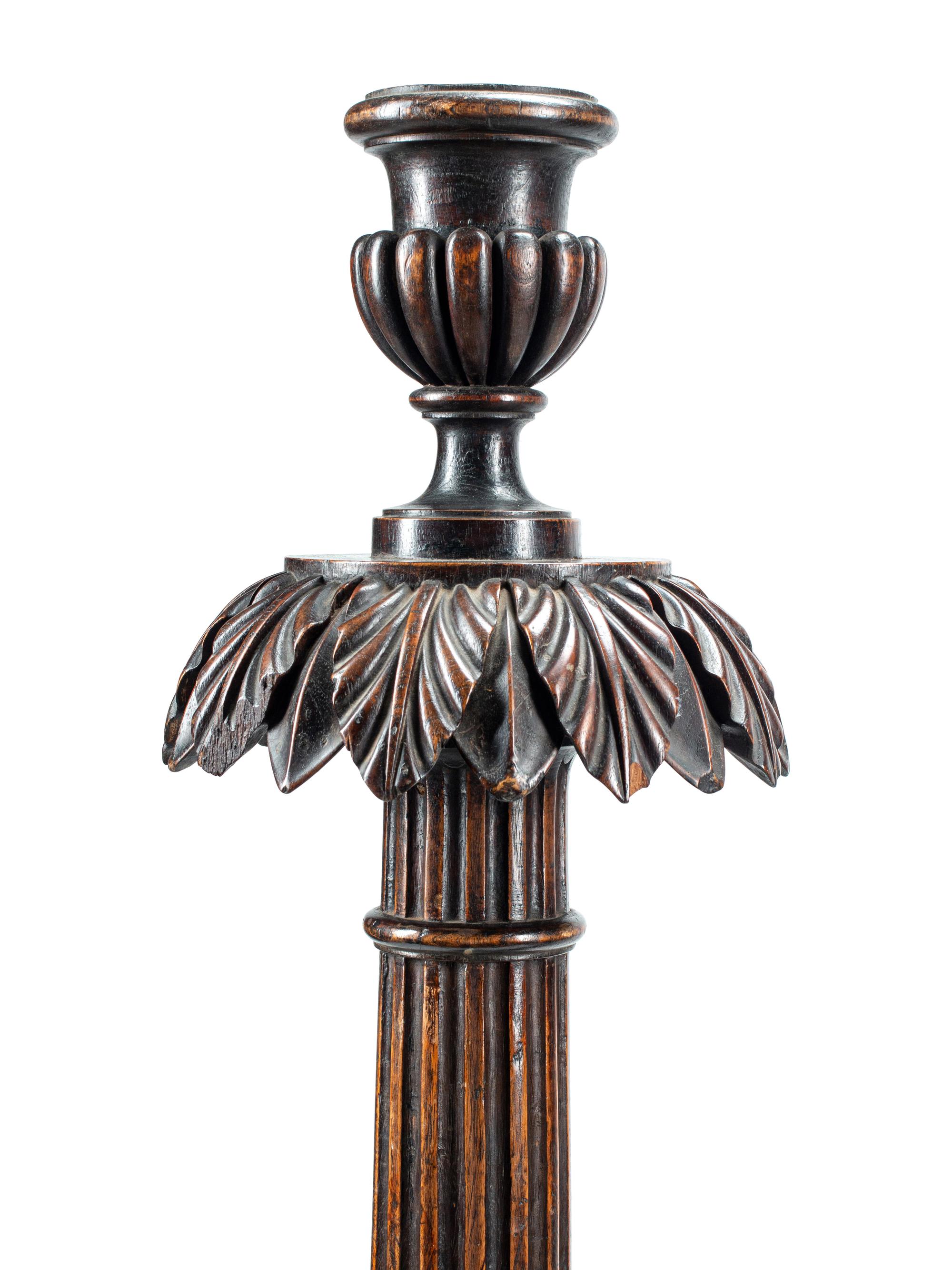 A Pair of Italian Carved Walnut Torchères