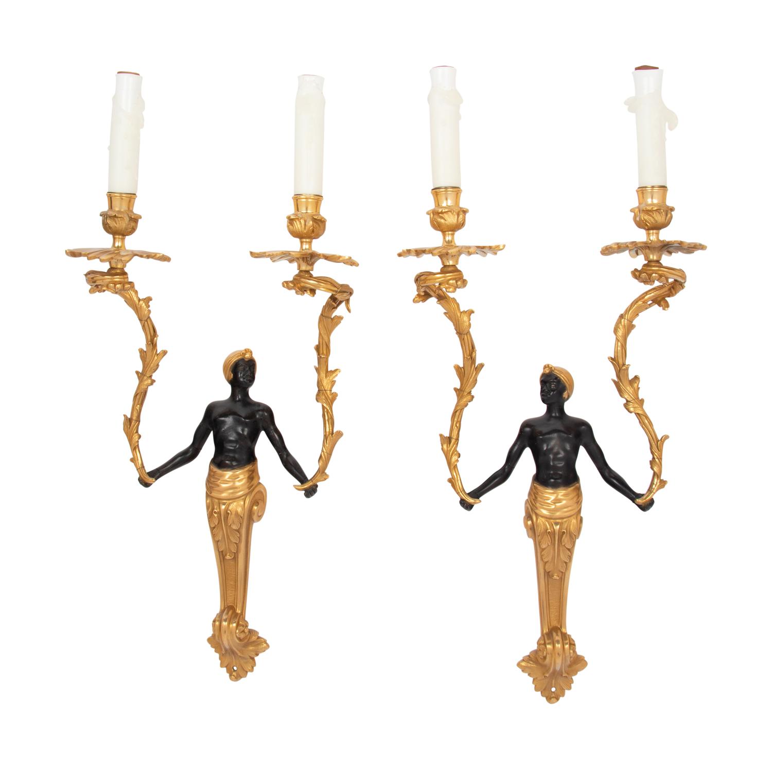 A Pair of French Gilt and Patinated Bronze Figural Two-Light Sconces
