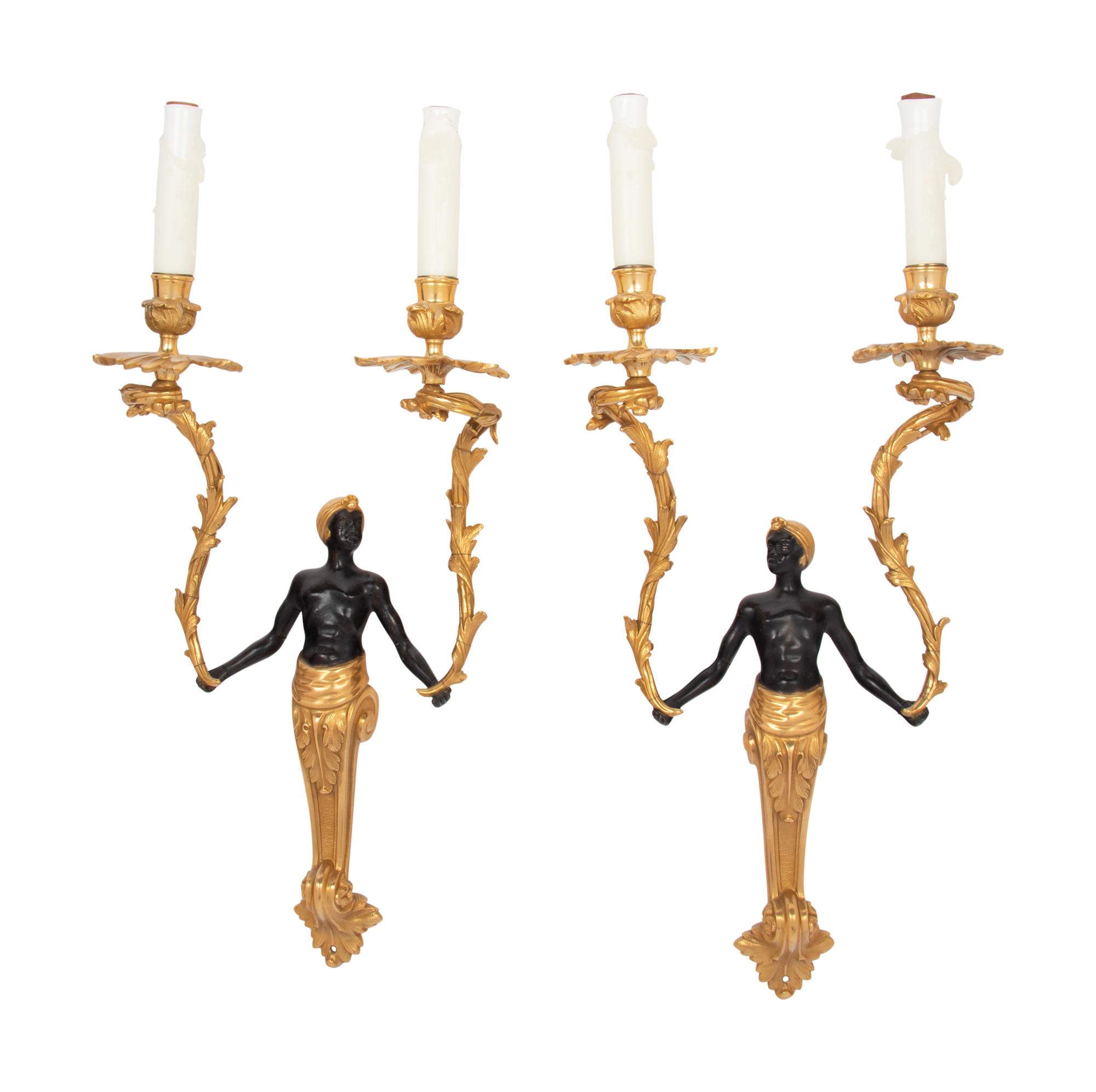 A Pair of French Gilt and Patinated Bronze Figural Two-Light Sconces