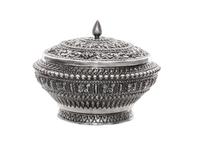 A Silver Box and Cover, Probably Thai, 20th Century, of circular form with allover repeating relief decoration.