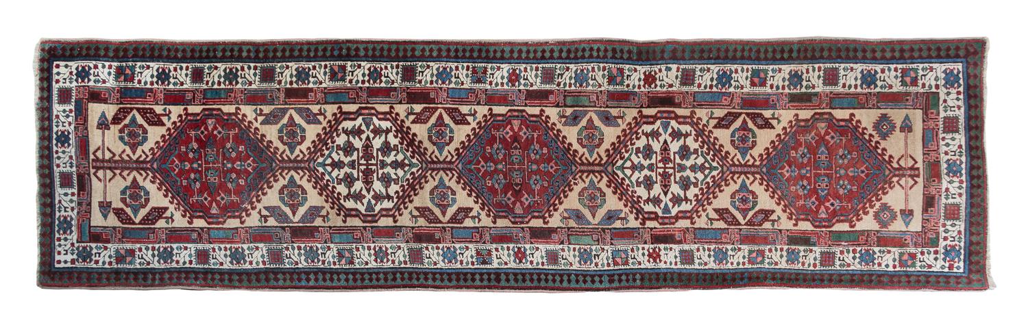 A Northwest Persian Wool Runner 10 feet 10 inches x 3 feet 1 inch.