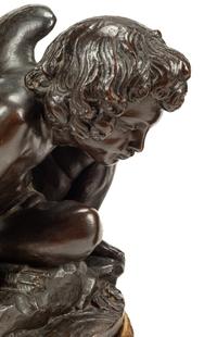 A Pair of Bronzed Composition Figures of Seated Cherubs