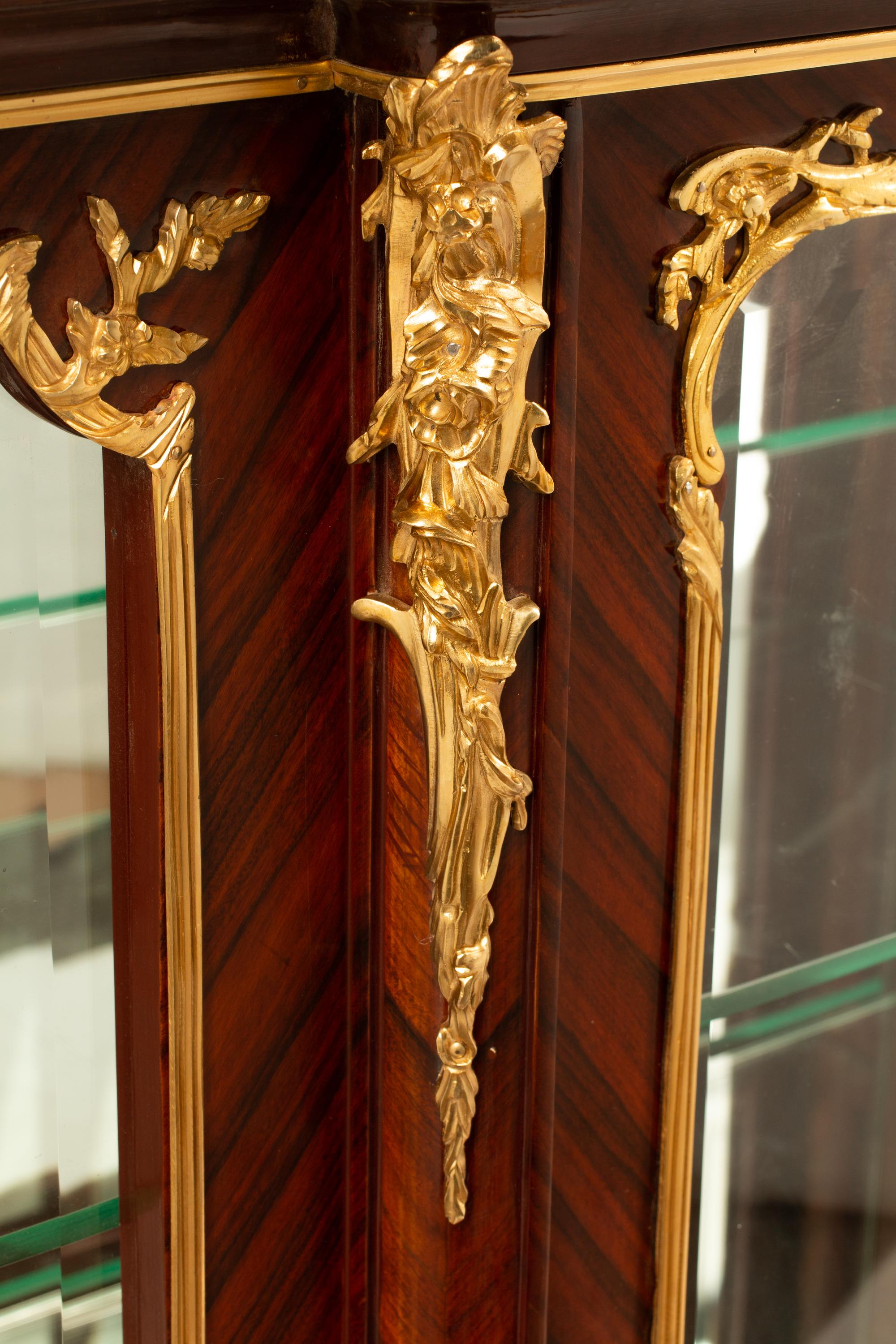 A Louis XV Style Gilt Bronze Mounted Marble-Top Vitrine Cabinet