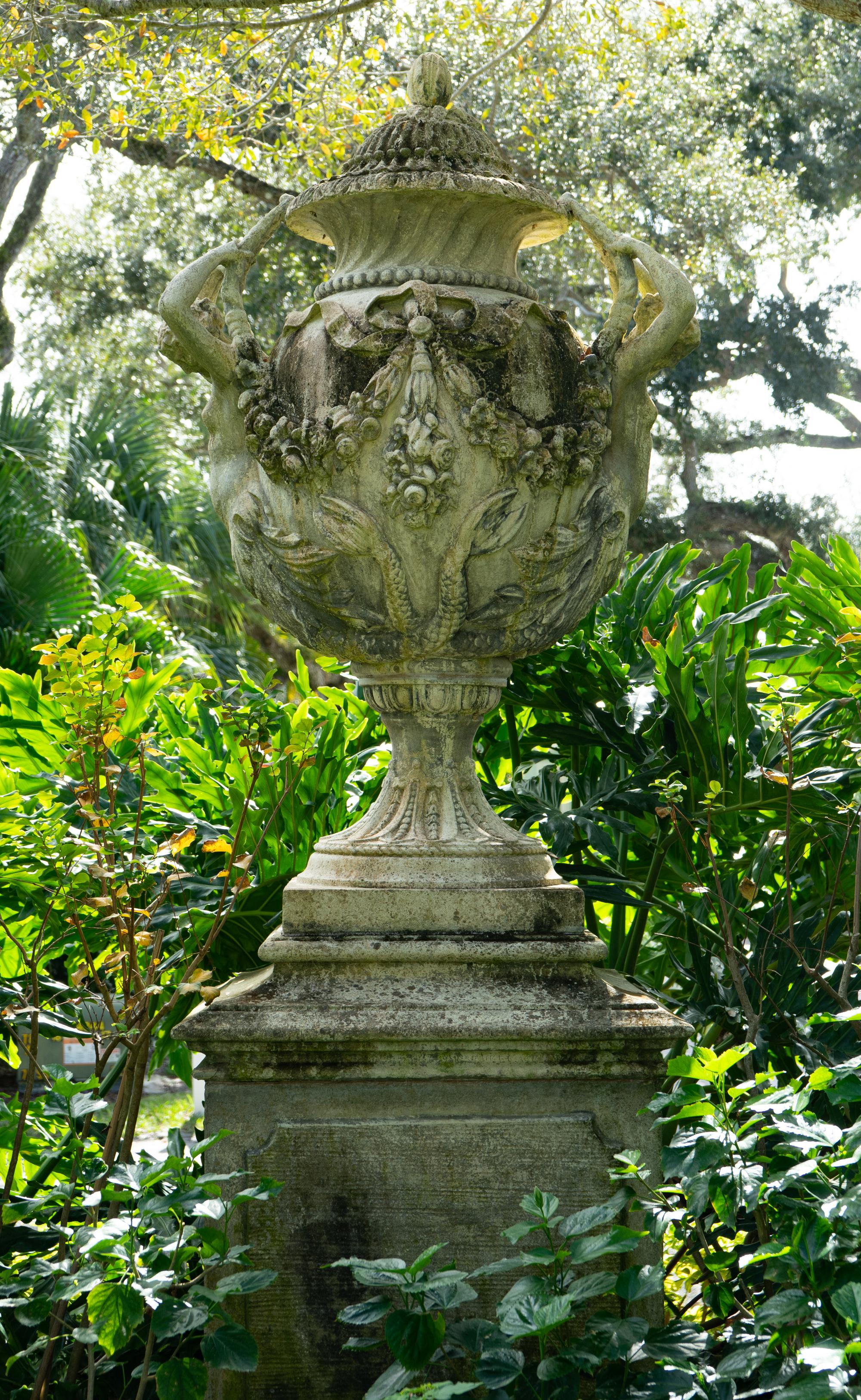 An English Monumental Carved Stone Urn on a Pedestal Base