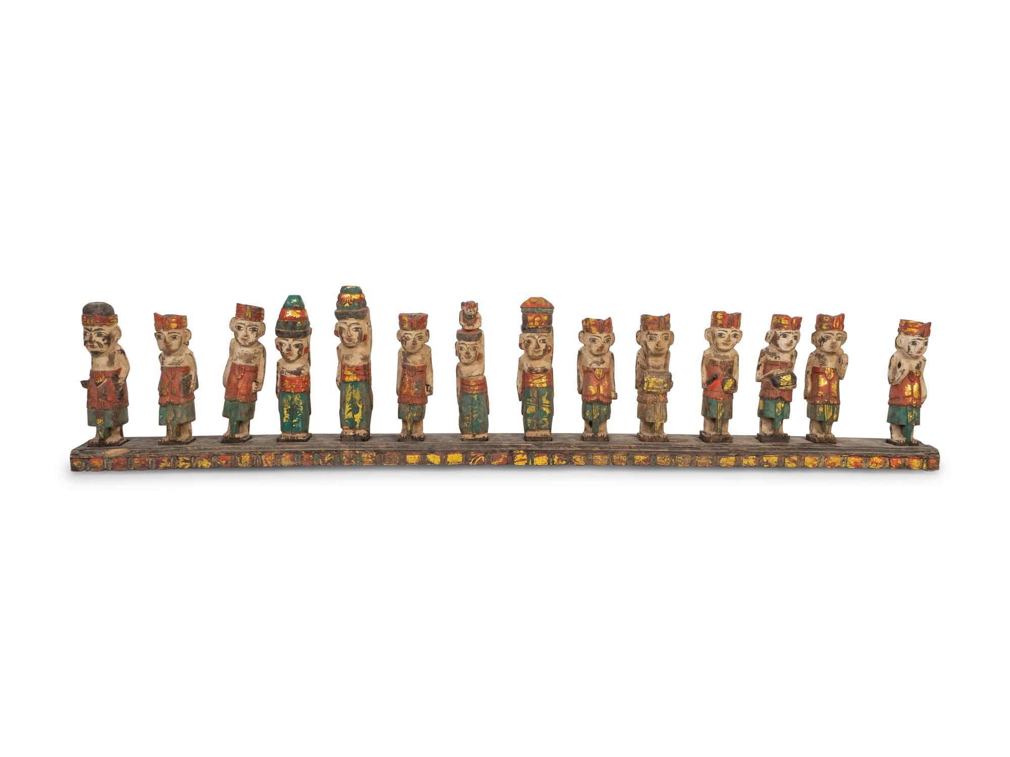 A Thai Parcel-Gilt and Polychromed Wood Group of Fourteen Musicians and Attendants