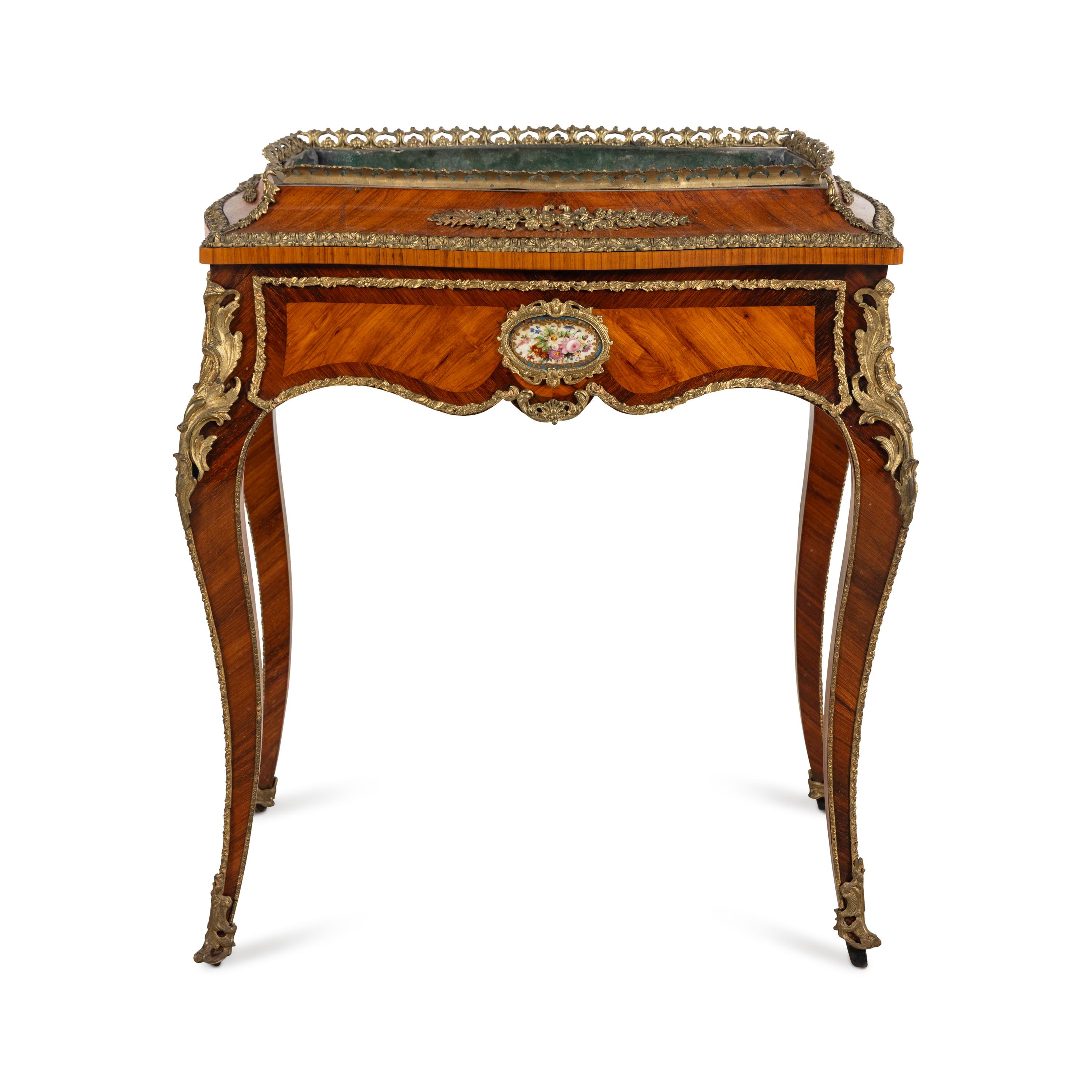 A French Kingwood, Tulipwood, Gilt Bronze and Porcelain Mounted Jardinière Table