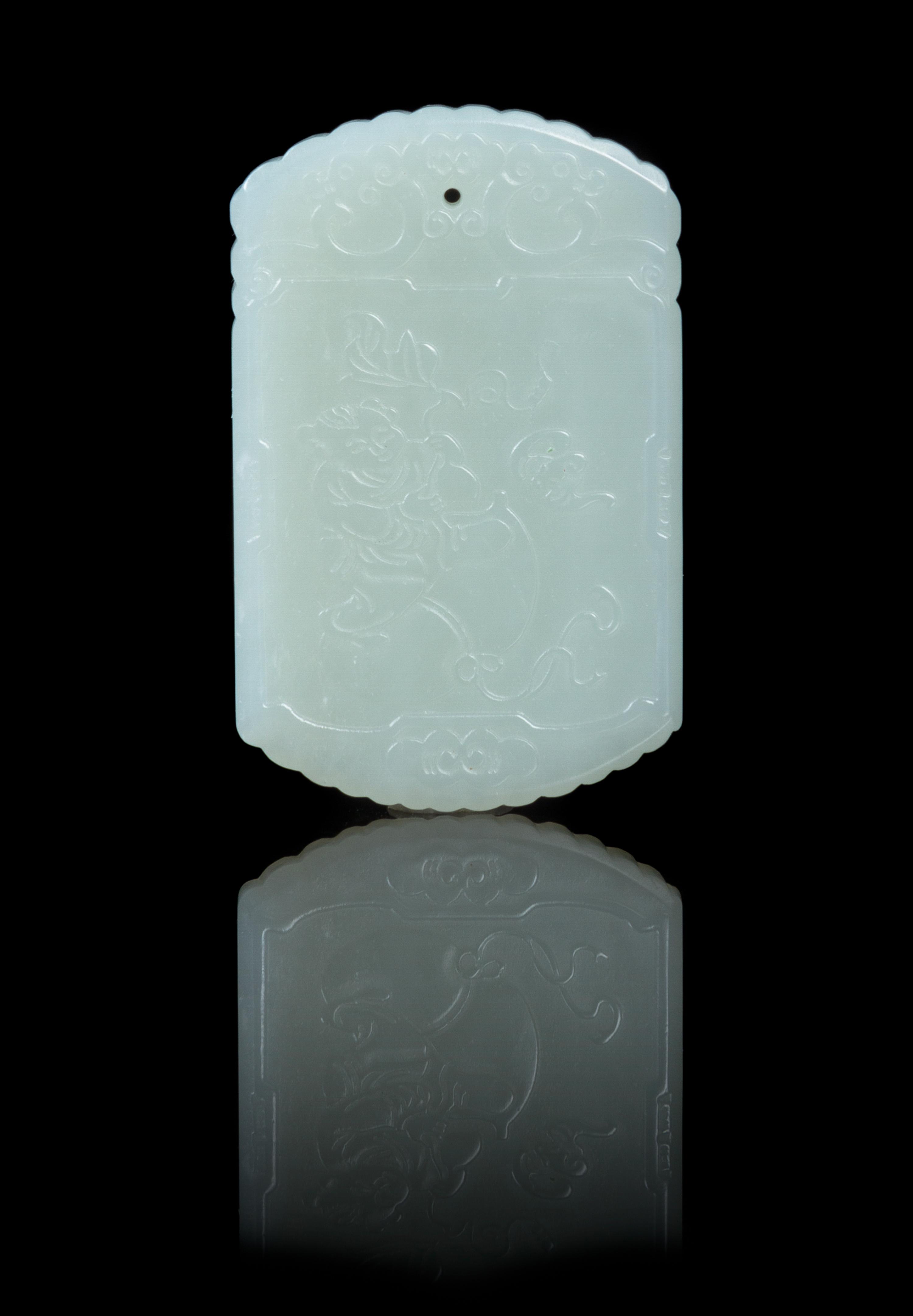A Carved Pale Celadon Jade Plaque Height 2 1/8 inches.