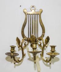 A Neoclassical Style Brass Three-Light Sconce Height of sconce 13 1/4 inches.