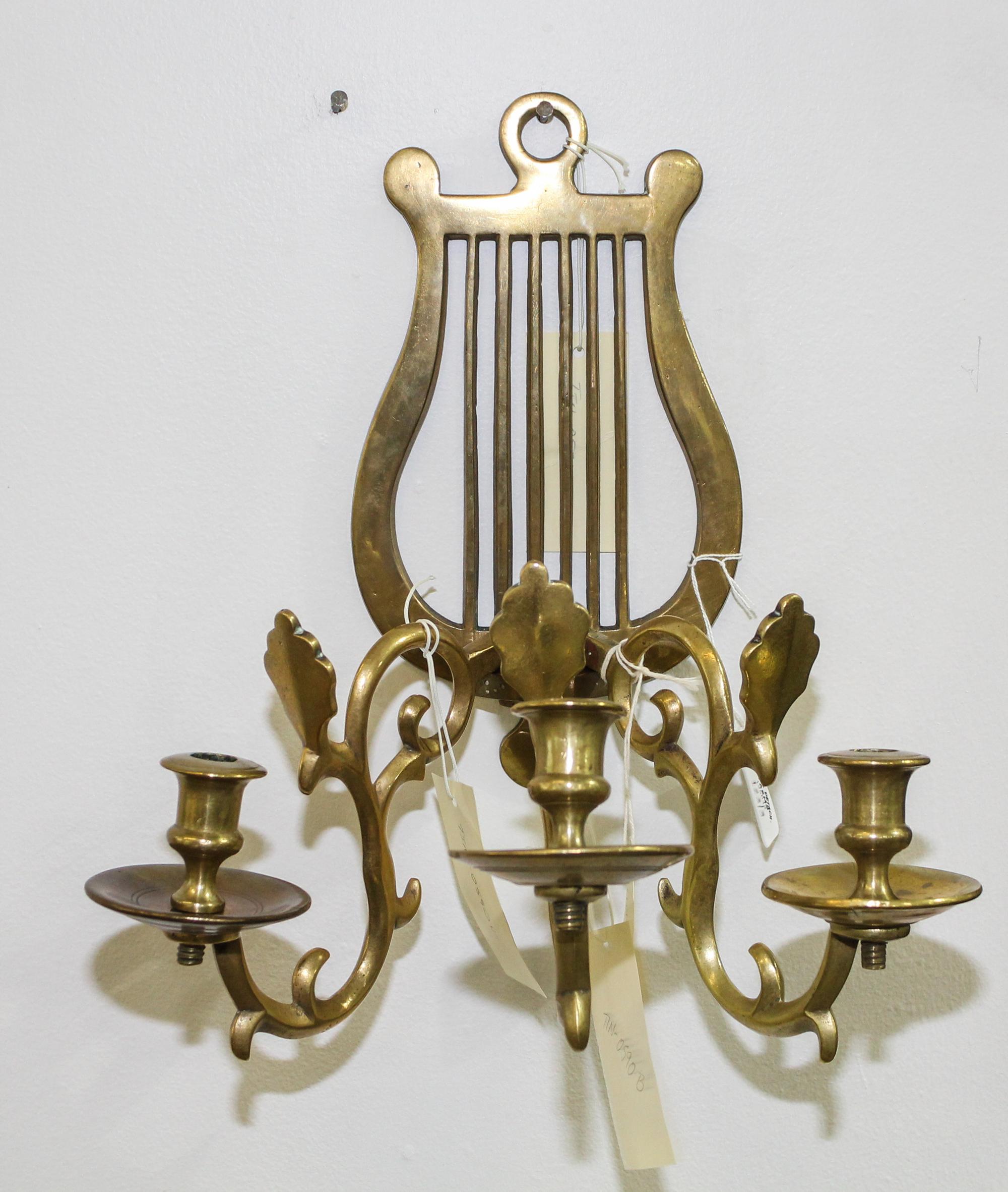 A Neoclassical Style Brass Three-Light Sconce Height of sconce 13 1/4 inches.