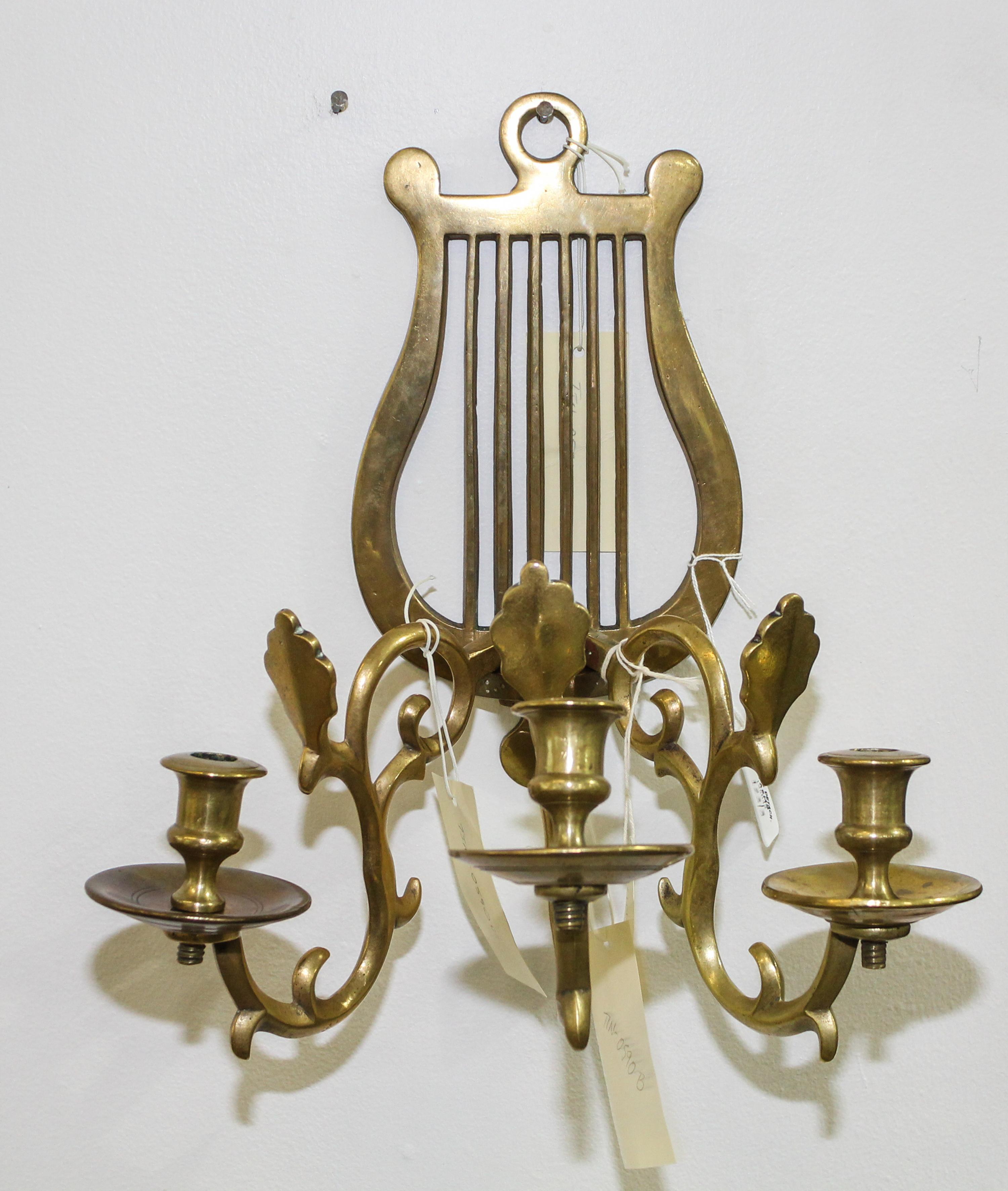 A Neoclassical Style Brass Three-Light Sconce Height of sconce 13 1/4 inches.