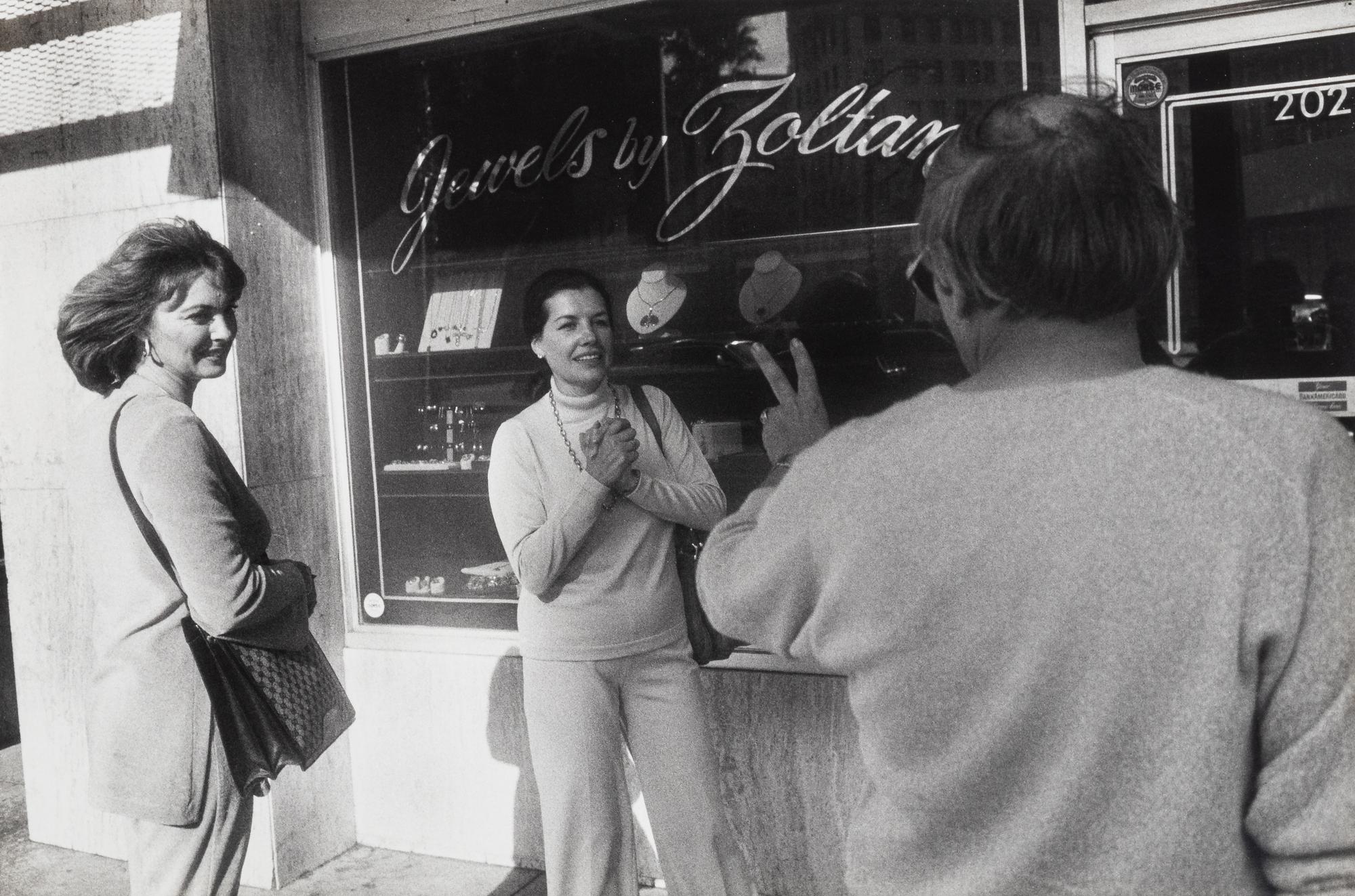 Garry Winogrand (1928-1984) Untitled (Two fans encountering a personality making the peace sign, Beverly Hills), from "Women are Better than Men...", 1982