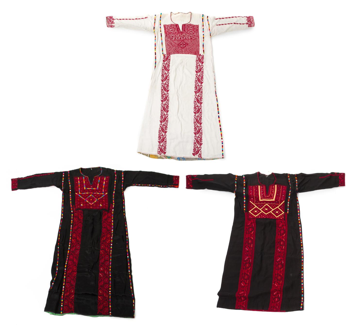 Three Palestinian Embroidered Silk Thawbs Length of first mentioned 56 inches. — 20TH CENTURY