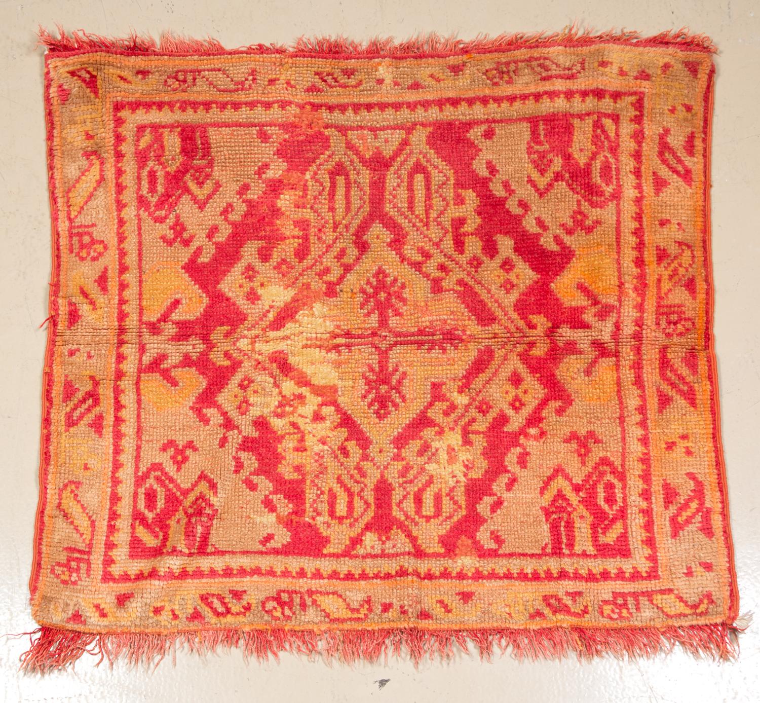 A Wool Area Rug 3 feet 3 3/4 inches x 3 feet 5 1/2 inches.