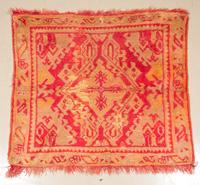 A Wool Area Rug 3 feet 3 3/4 inches x 3 feet 5 1/2 inches.