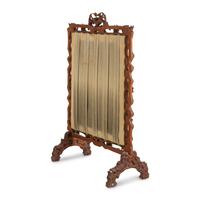 A Swiss "Black Forest" Carved Needlepoint-Inset Firescreen