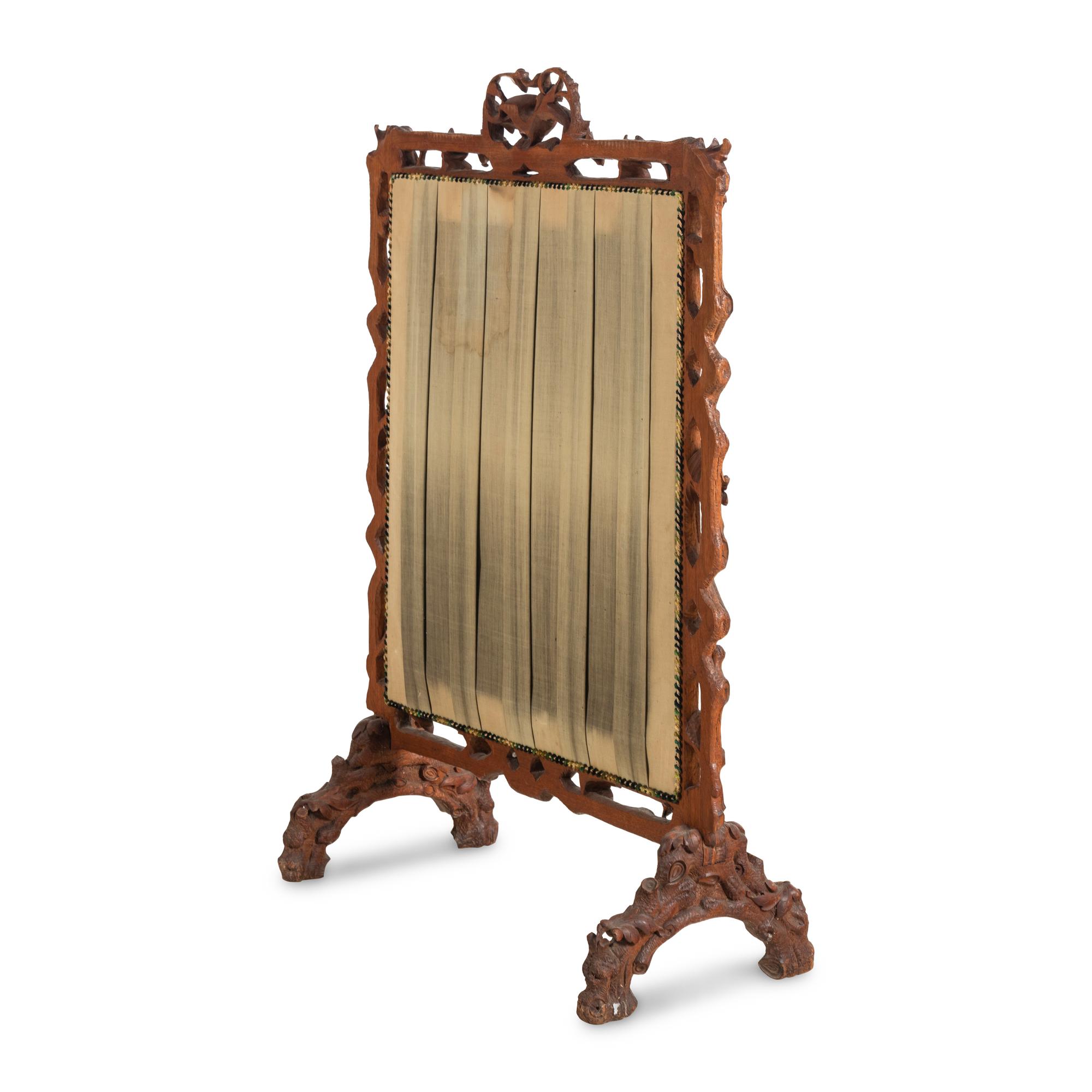 A Swiss "Black Forest" Carved Needlepoint-Inset Firescreen