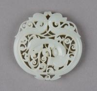 A Pierced Celadon Jade Roundel, Height 2 1/8 inches.