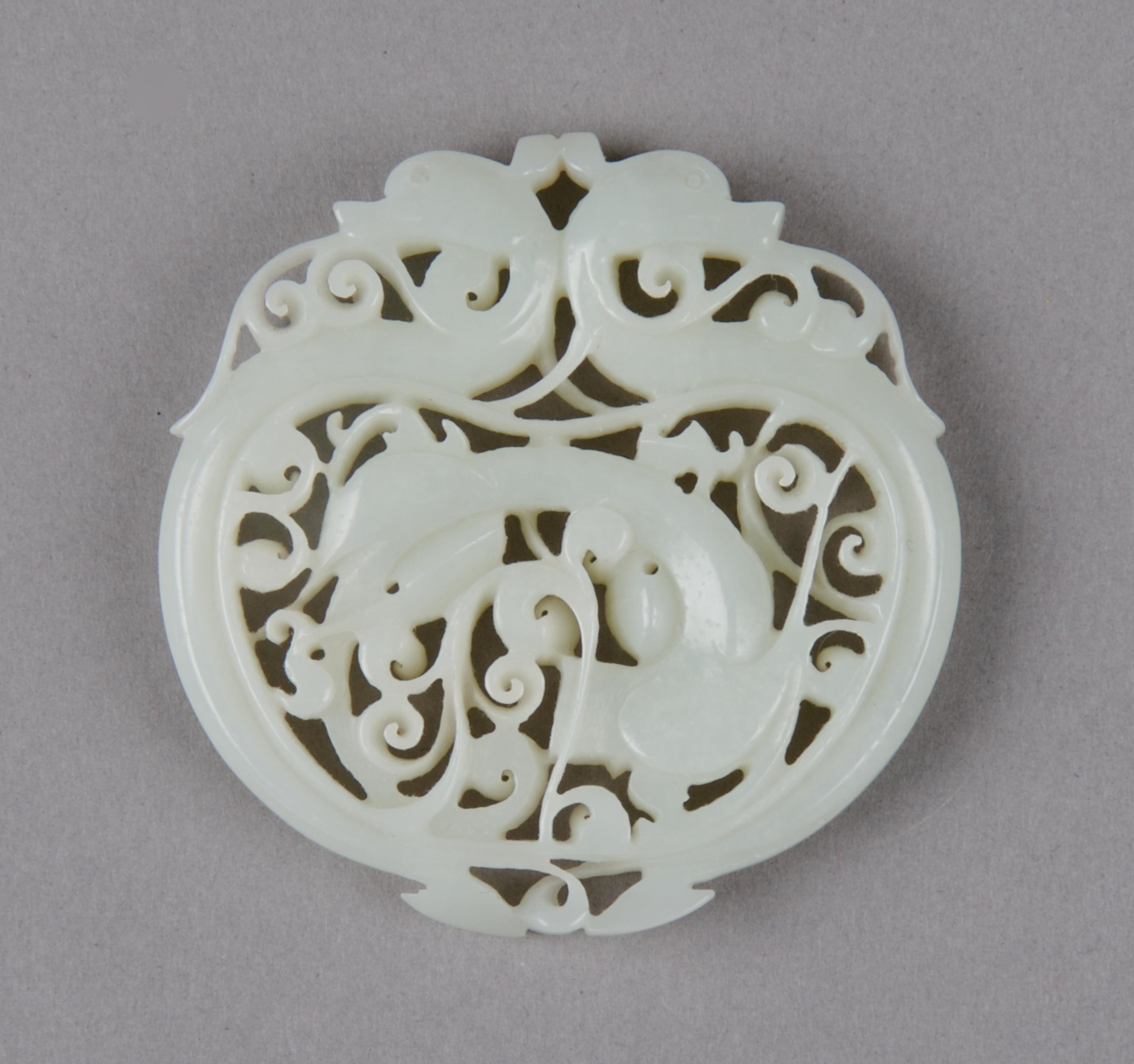 A Pierced Celadon Jade Roundel, Height 2 1/8 inches.