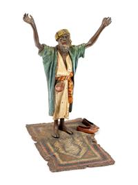 An Austrian Cold-Painted Bronze Figure of a Man Praying on a Carpet