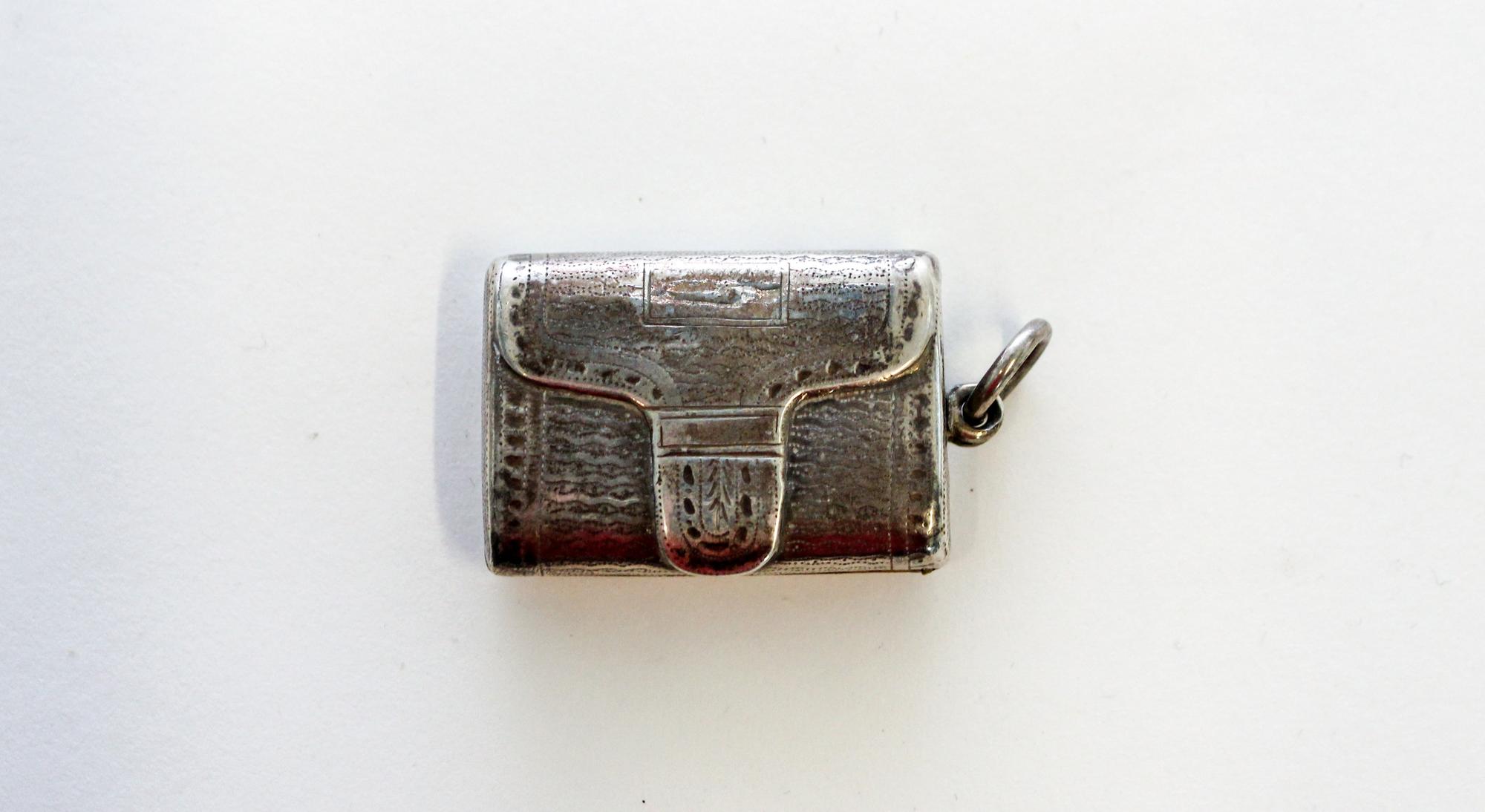 A George III Silver Vinaigrette, John Shaw, Birmingham, 1816, of rectangular form, the exterior decorated in the form of a satchel and