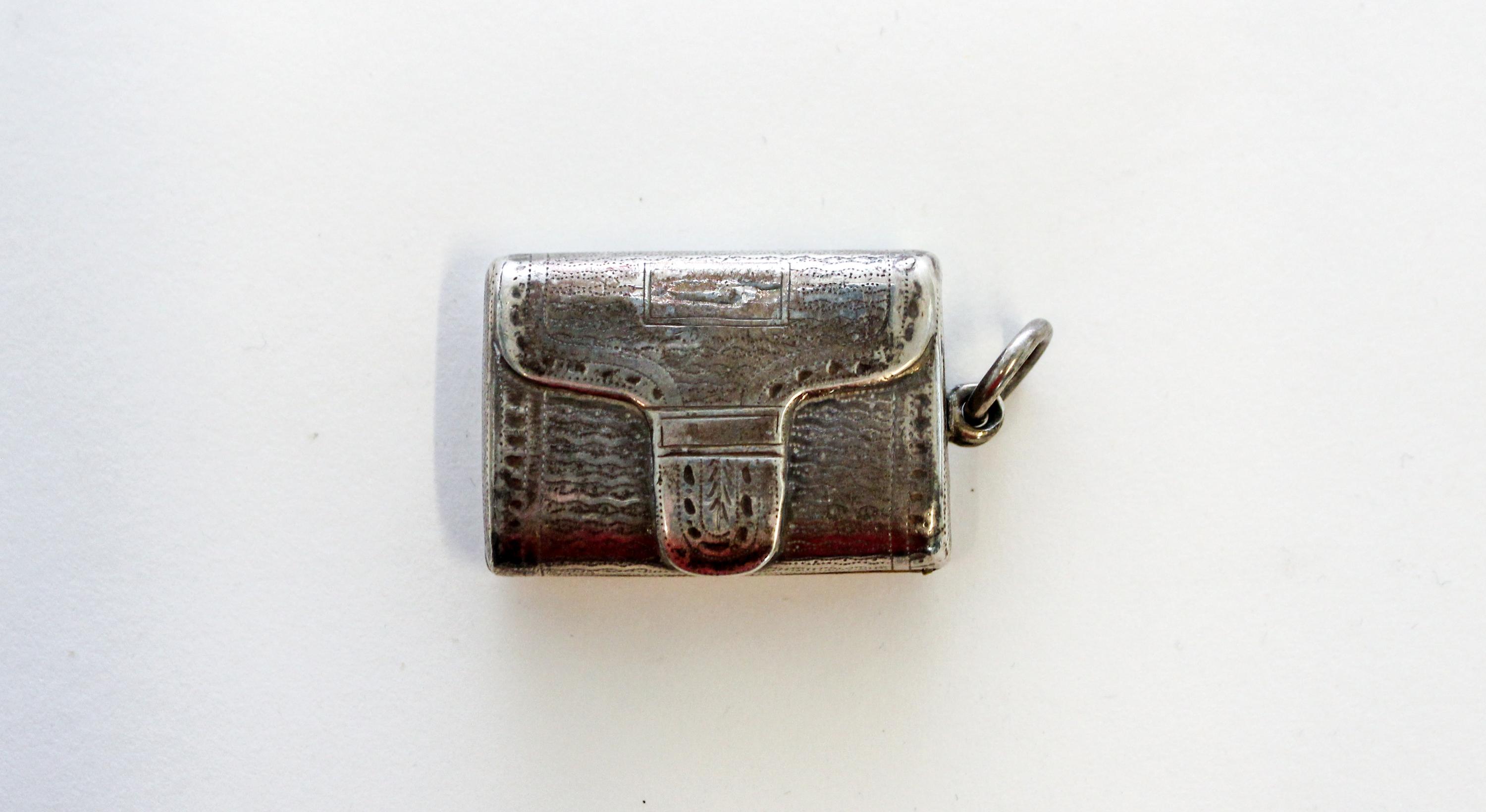 A George III Silver Vinaigrette, John Shaw, Birmingham, 1816, of rectangular form, the exterior decorated in the form of a satchel and