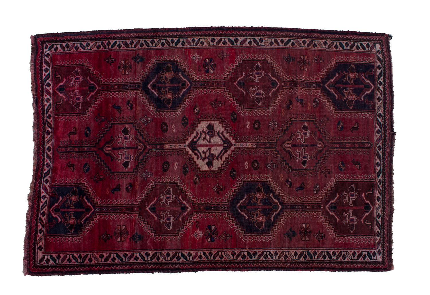 A Persian Wool Rug 5 feet 5 1/2 inches x 7 feet 10 3/4 inches.