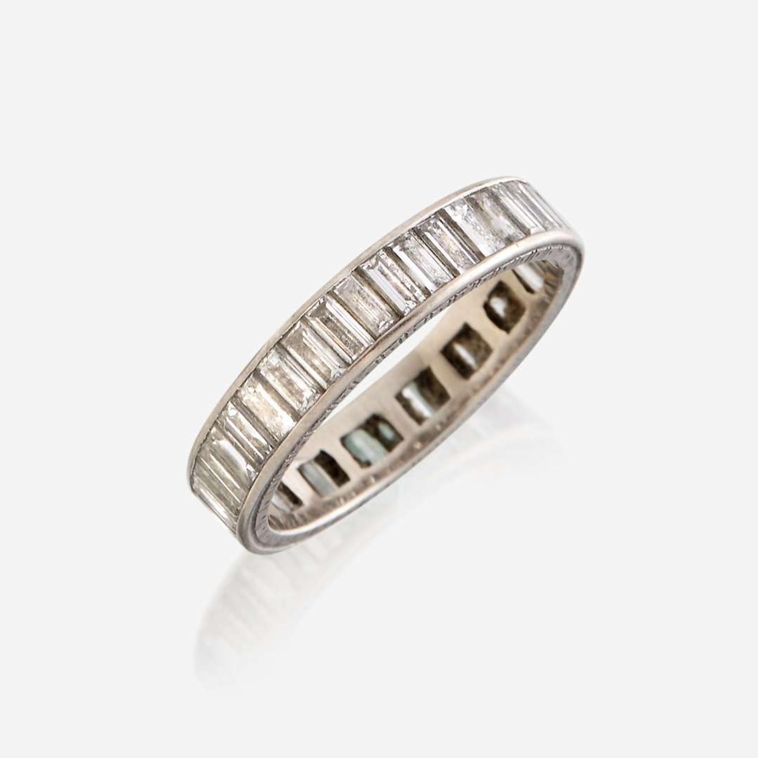 A diamond and fourteen karat white gold eternity band