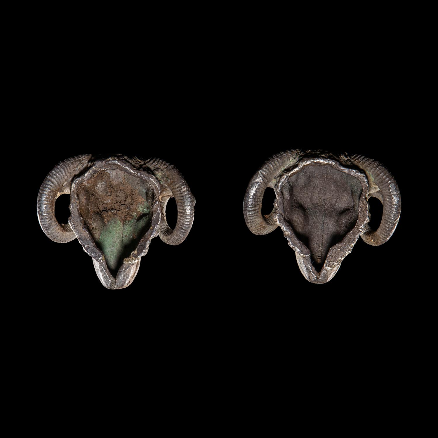 A Pair of Hellenistic Silver Ram's Head Appliques