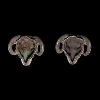 A Pair of Hellenistic Silver Ram's Head Appliques