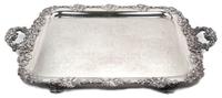 An English Silver-Plate Handled Tray, , having C-scroll handles, with grapevine border centered with a monogram, raised on feet.