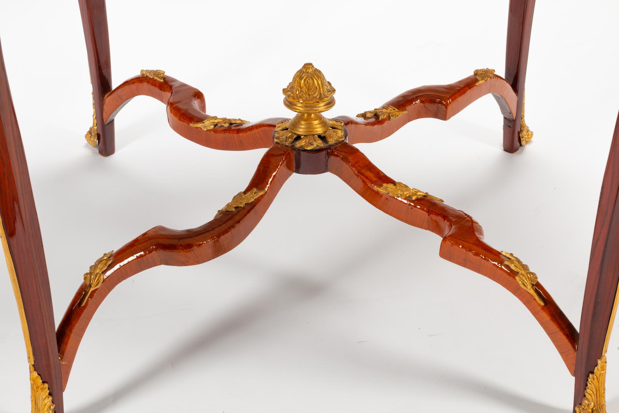 A Louis XV Style Gilt Bronze Mounted Parquetry Center Table with a Tiger's Eye Top