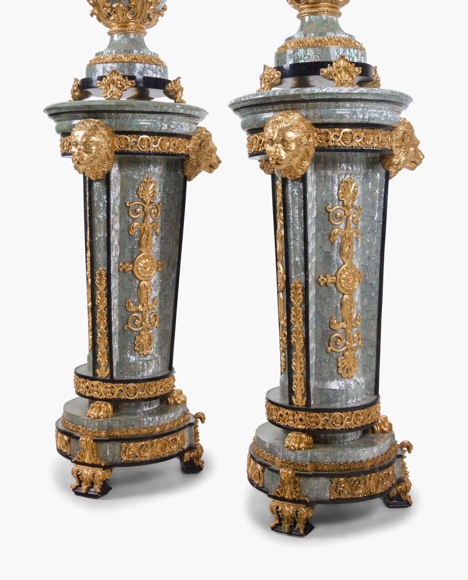 A Pair of Neoclassical Style Gilt Composite and Abalone Veneered Urns and Pedestals