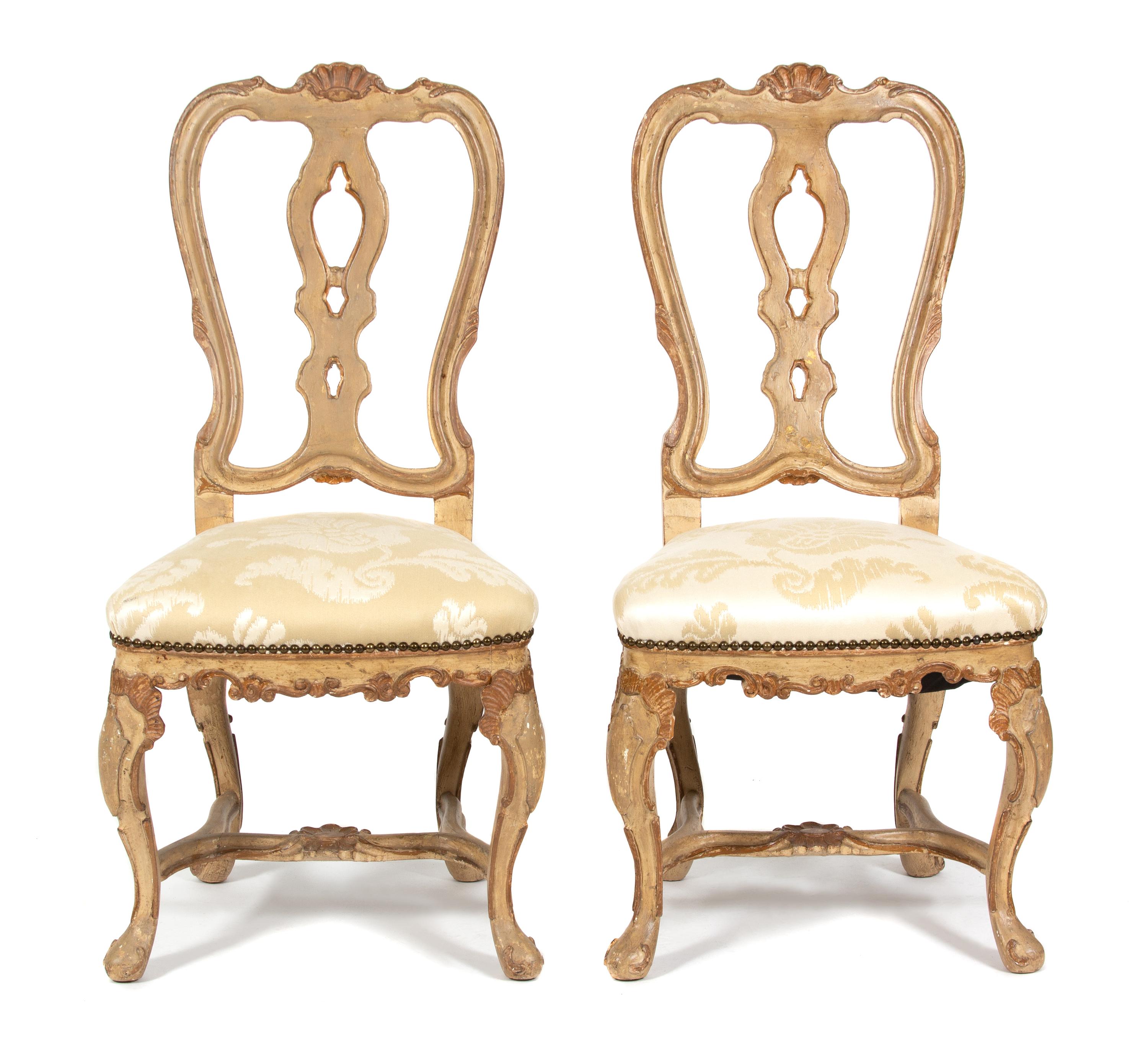A Set of Twelve Italian Rococo Style Painted Dining Chairs Height 42 1/2 inches. — 19TH CENTURY