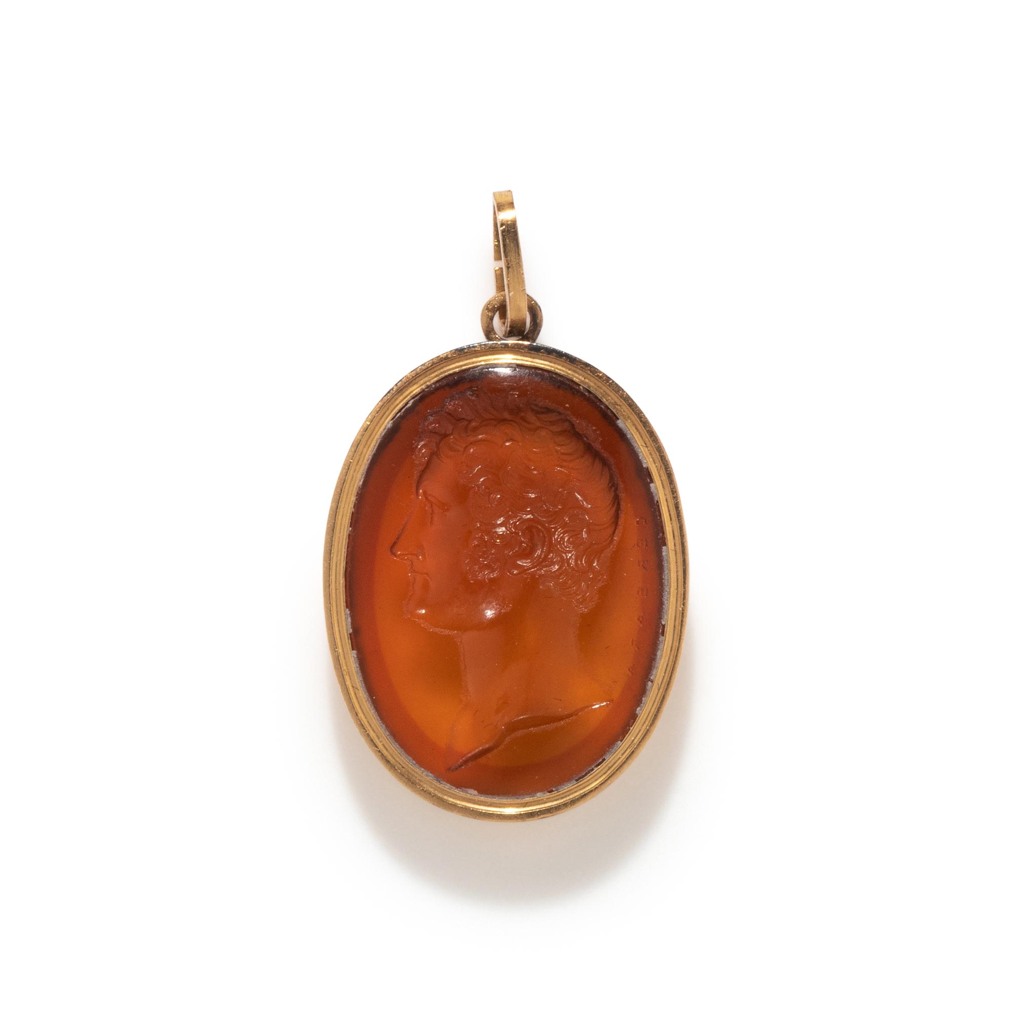 A Victorian Gold and Glass Pendant with a Male Portrait Bust