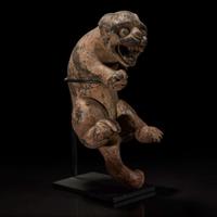 A carved and painted wood figure of a rampant feline 木雕大猫