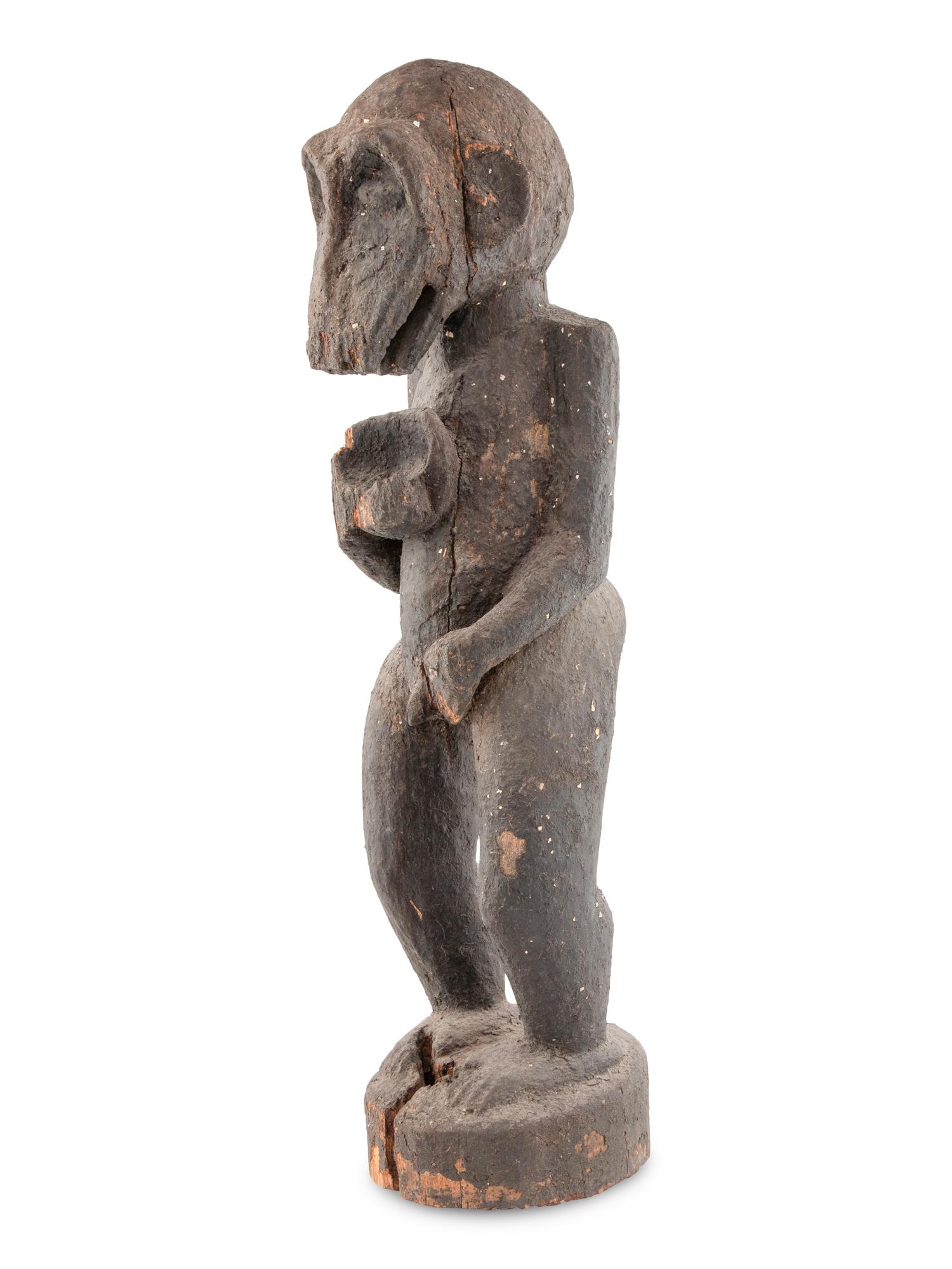 A Carved Wood and Black Painted Monkey Figure