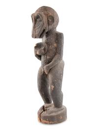 A Carved Wood and Black Painted Monkey Figure