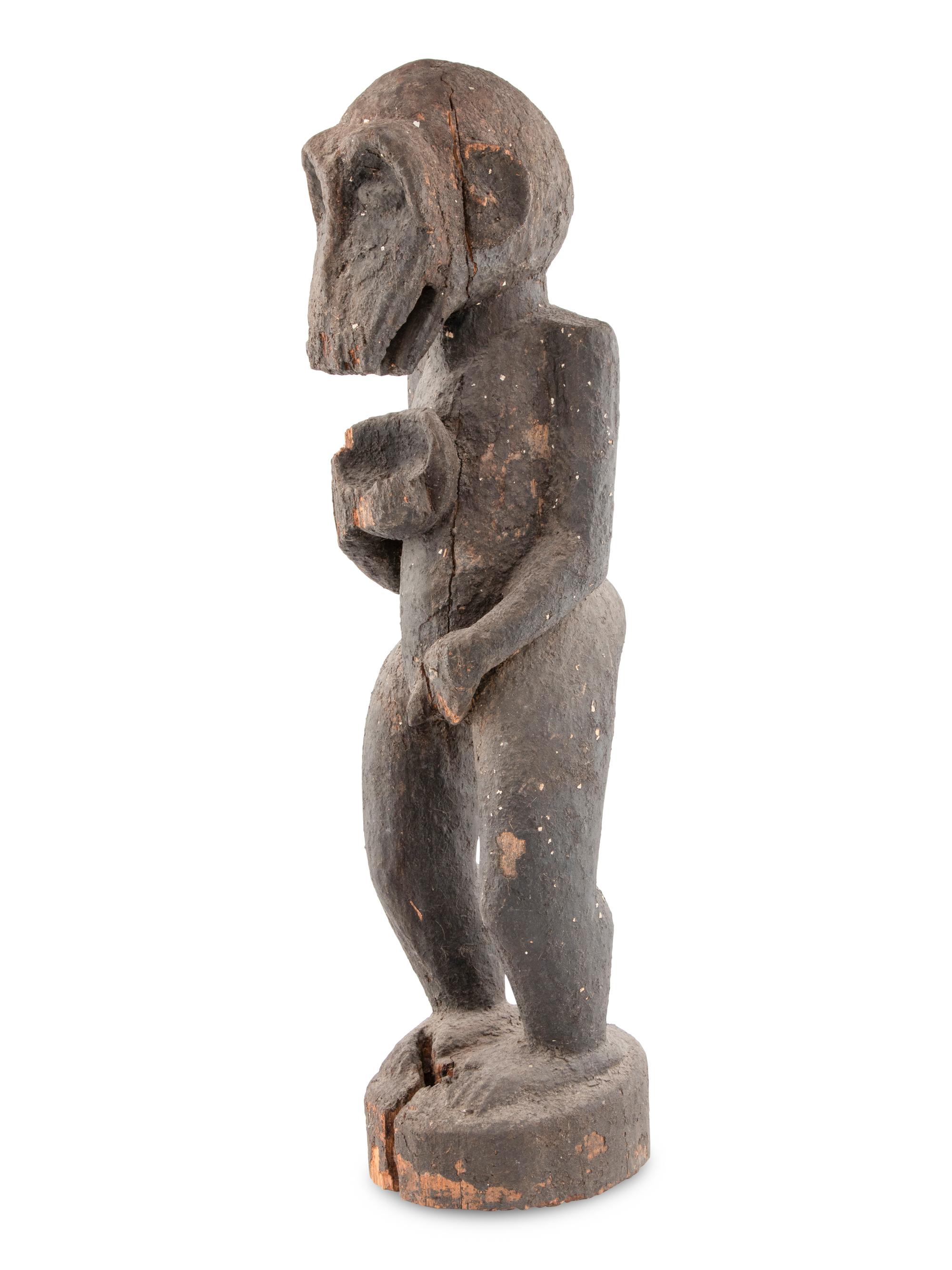 A Carved Wood and Black Painted Monkey Figure