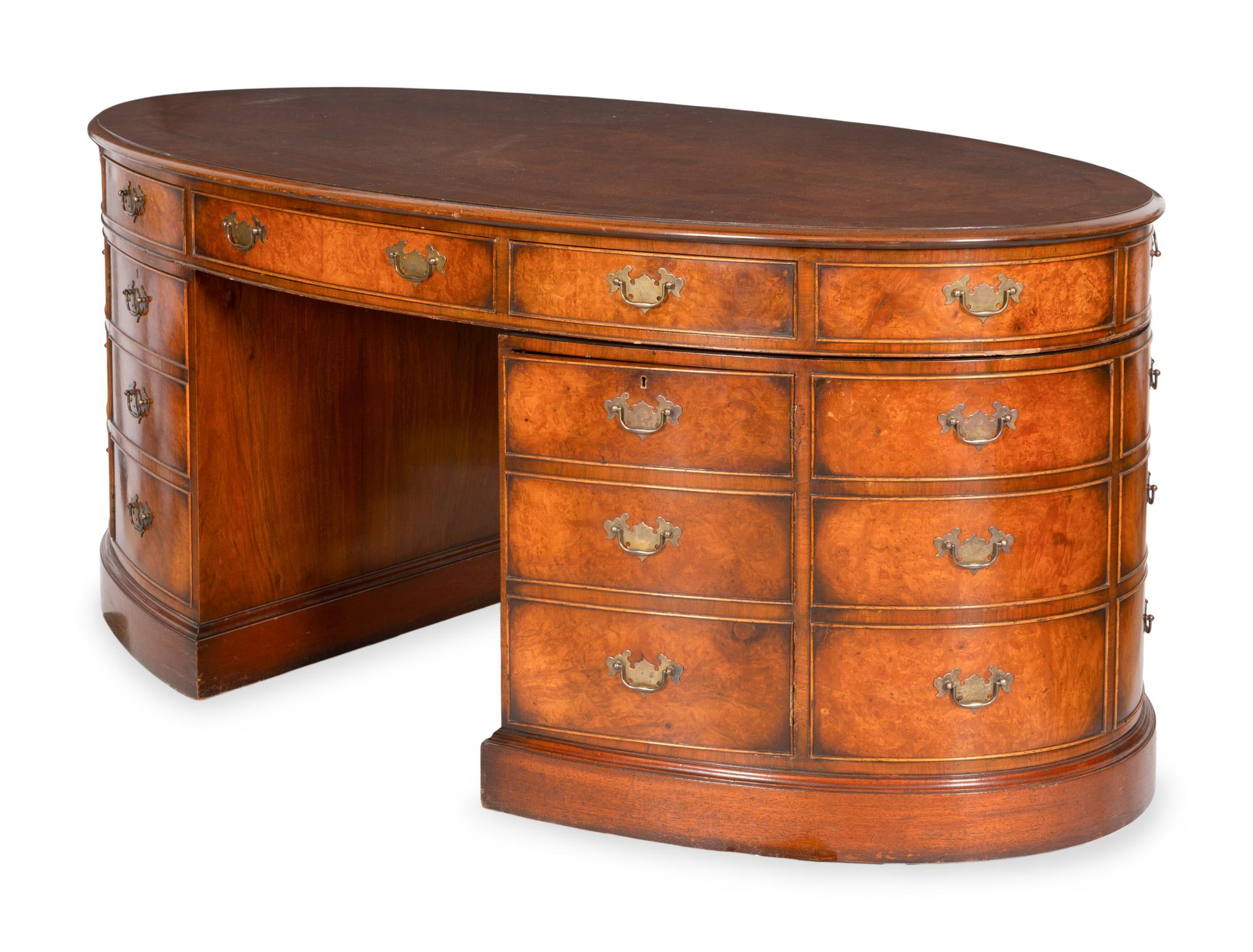 A George III Style Burl Walnut and Mahogany Oval Pedestal Desk