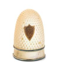 A French Palais Royal Mother-of-Pearl Thimble, 19th Century, the domed body with an applied shield form gilt metal cartouche bearing an