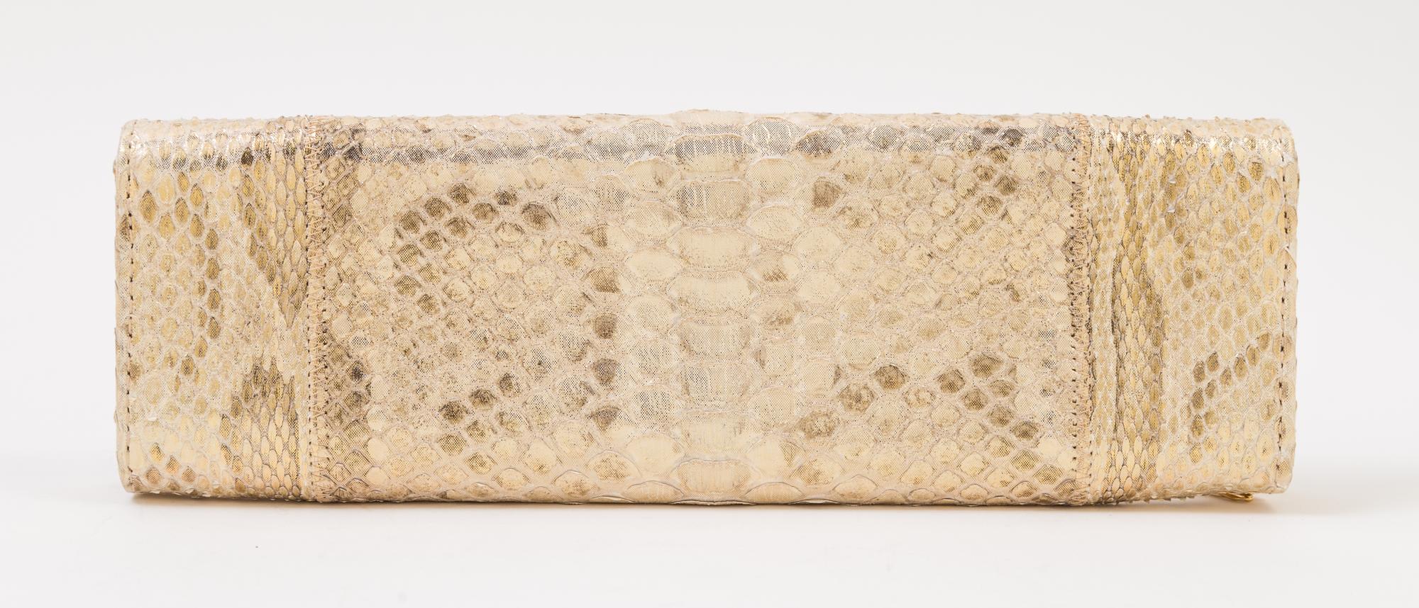 A Carlos Falchi Gold Snakeskin Clutch, 10" x 3.5" x 1".