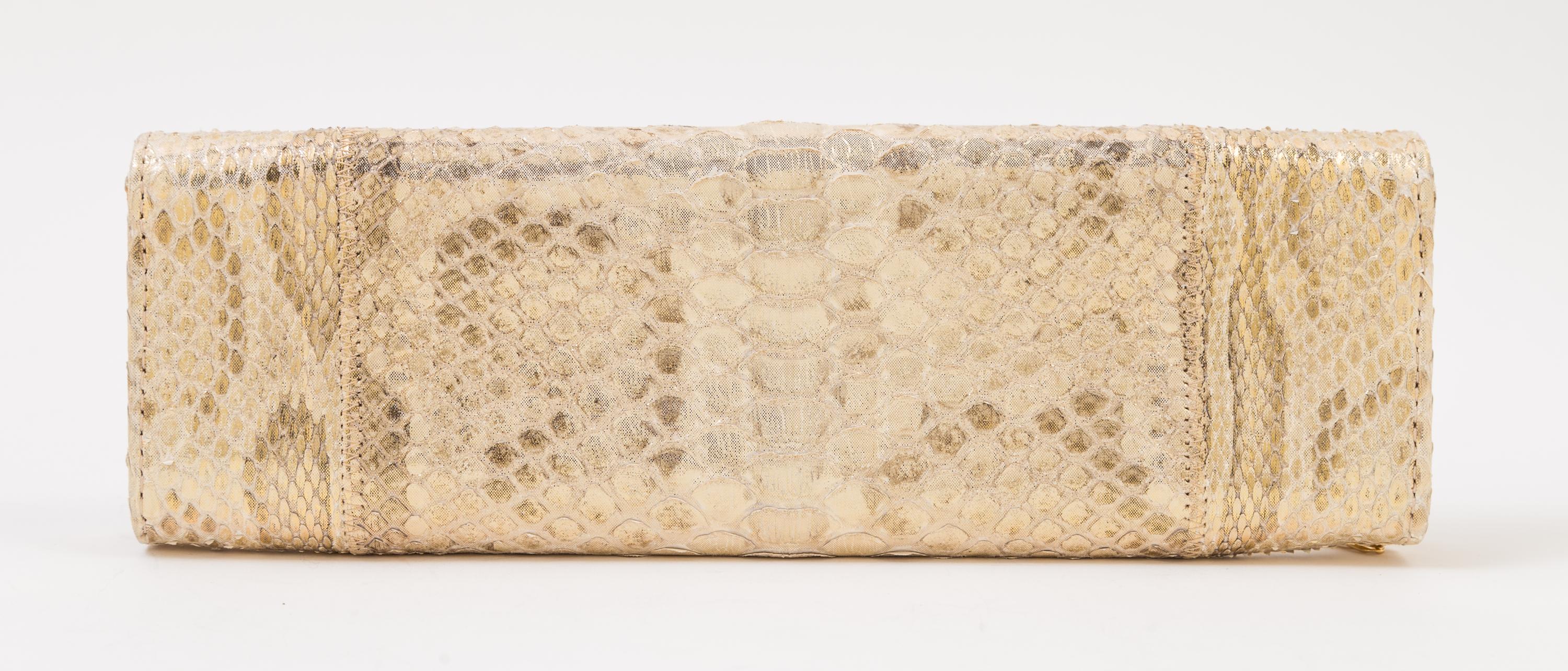A Carlos Falchi Gold Snakeskin Clutch, 10" x 3.5" x 1".