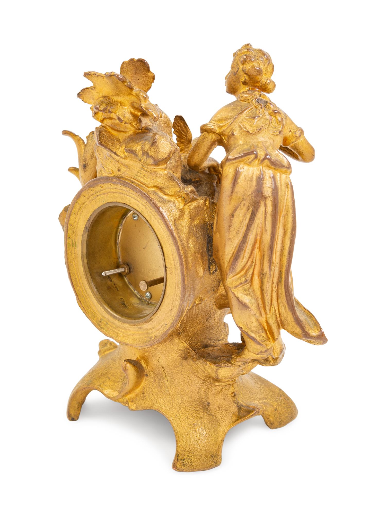 A Louis XV Style Gilt Metal Figural Clock with German Movement