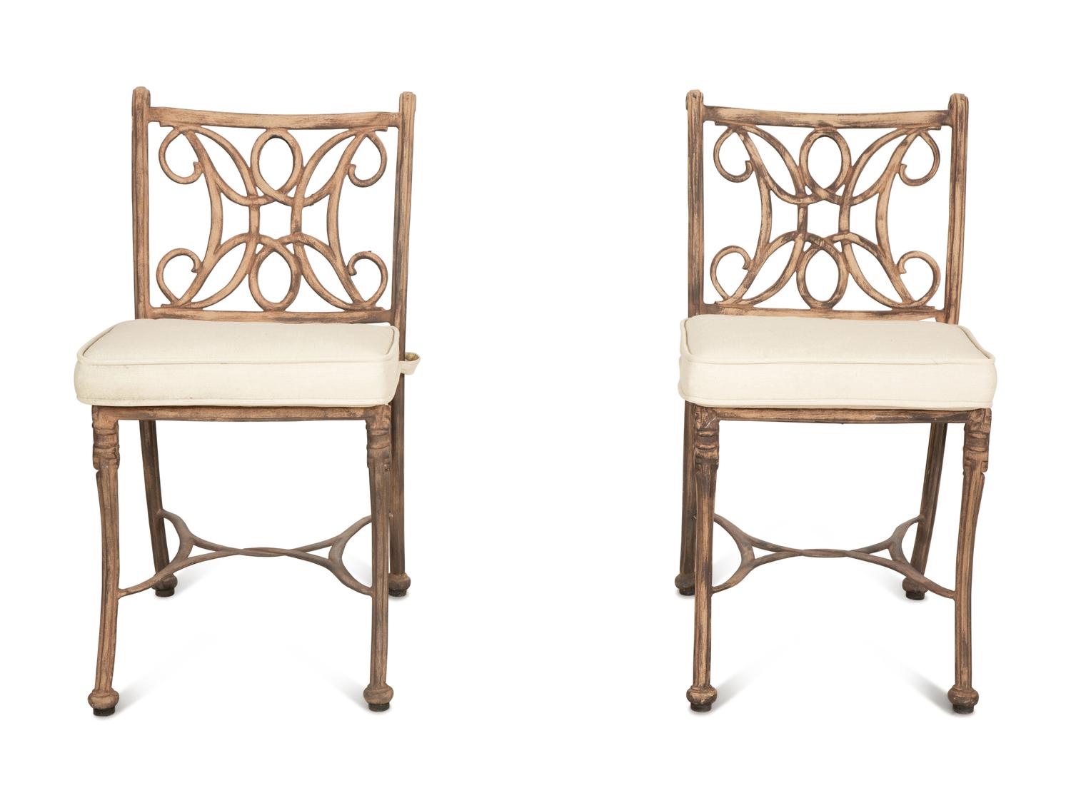 A Pair of Patinated Metal Garden Chairs and Side Table